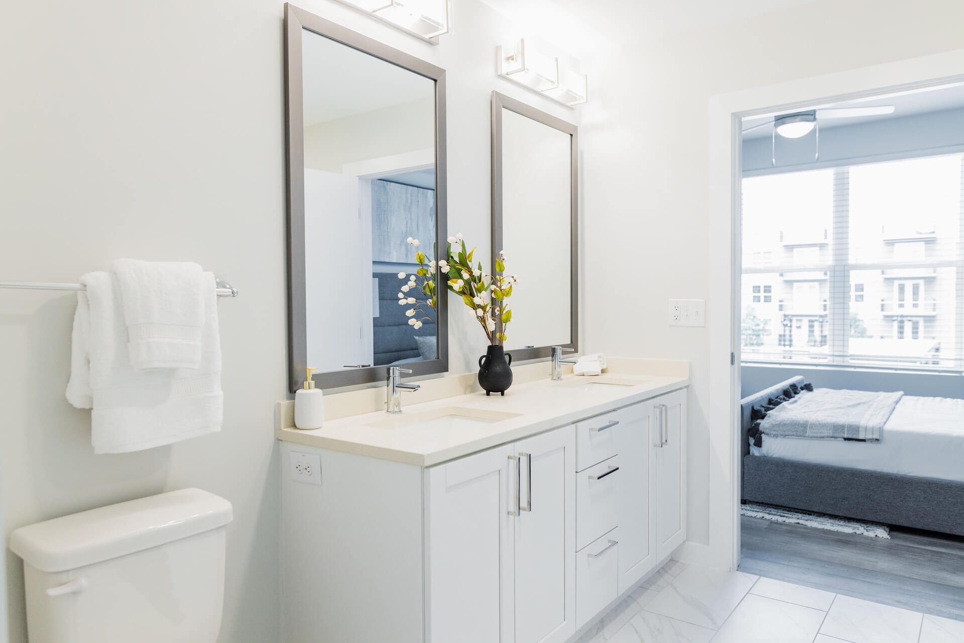 Polished Bathroom With Quartz Countertops And Pearl Paneled Cabinets